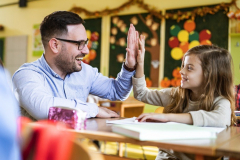 Facebook-happy-teacher-and-schoolgirl-giving-each-other-highfive-on-a-class-picture-id1210927485